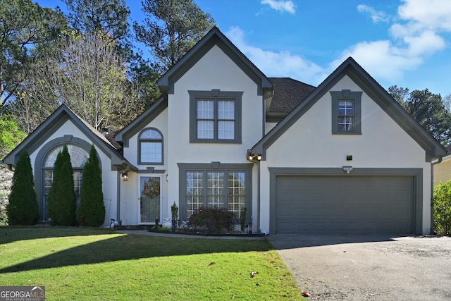 view of front of property featuring a front yard and a garage