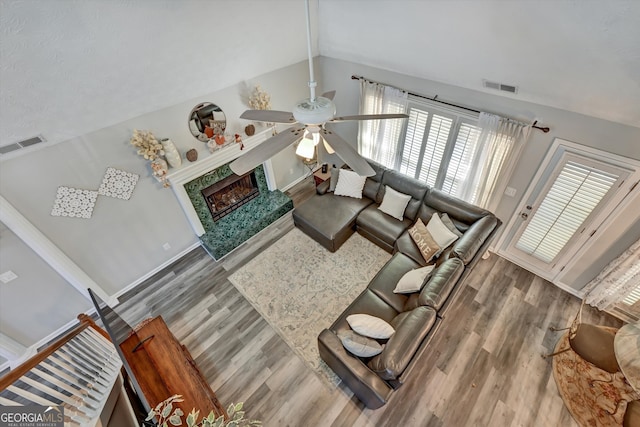 living room with hardwood / wood-style floors, a healthy amount of sunlight, and lofted ceiling