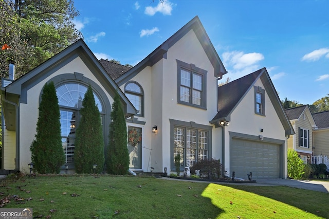 view of front of house with a garage and a front lawn