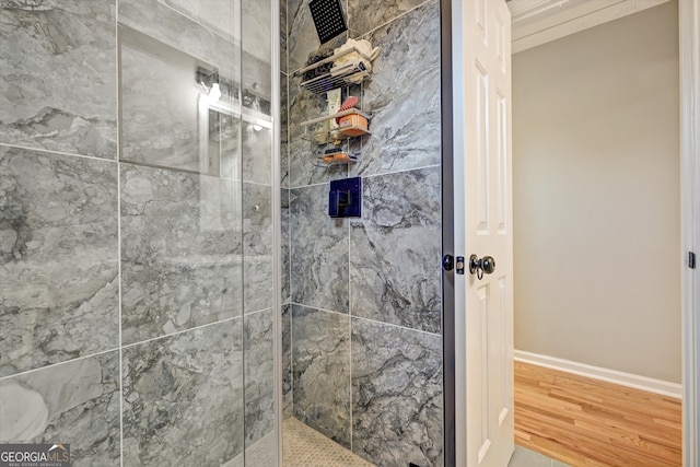 bathroom with wood-type flooring and a shower with door