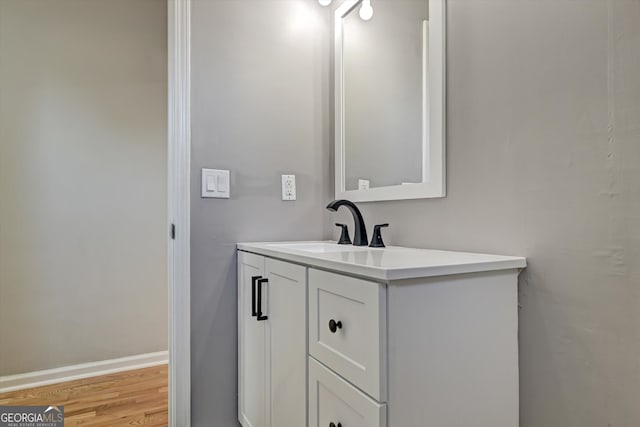 bathroom with hardwood / wood-style floors and vanity