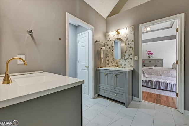 bathroom featuring vanity and vaulted ceiling