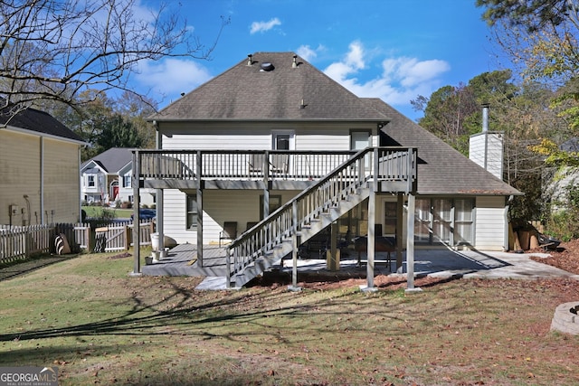 back of house with a lawn, a patio, and a wooden deck