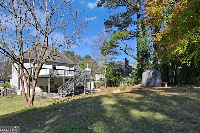 view of yard with a patio, a storage shed, and a wooden deck