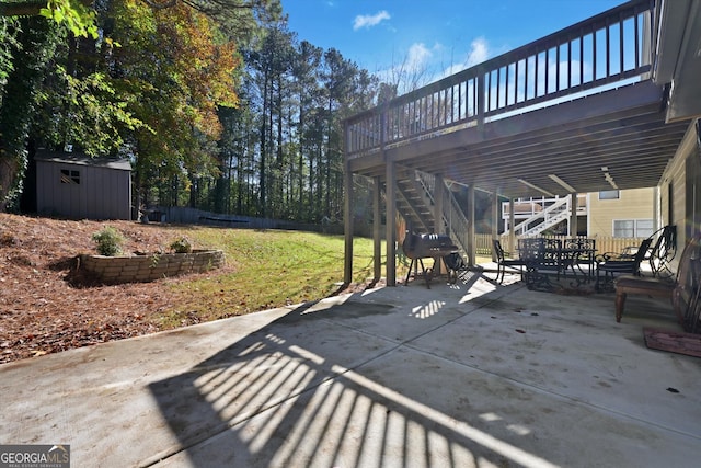 view of patio featuring a shed and a deck