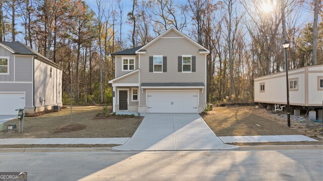 view of front facade featuring a front yard and a garage