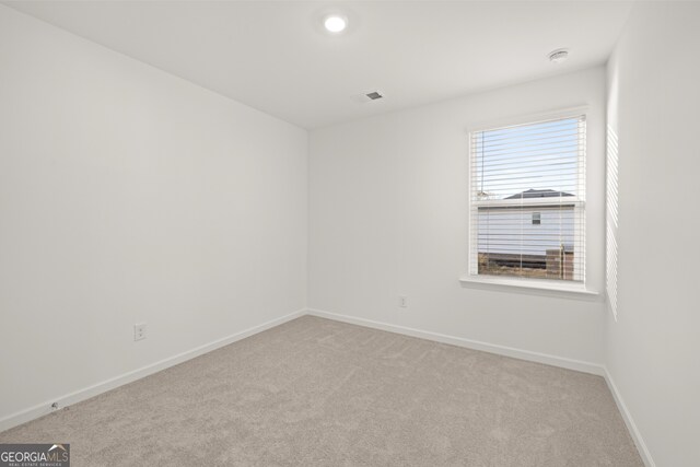 bedroom with connected bathroom, sink, multiple windows, and hardwood / wood-style flooring