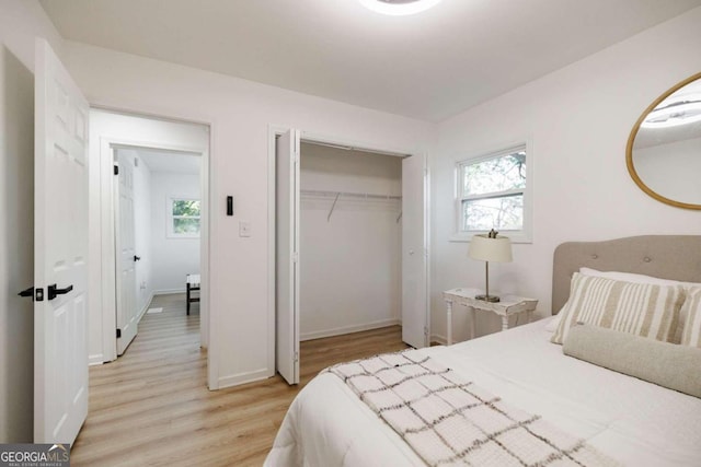 bedroom with a closet and light hardwood / wood-style flooring