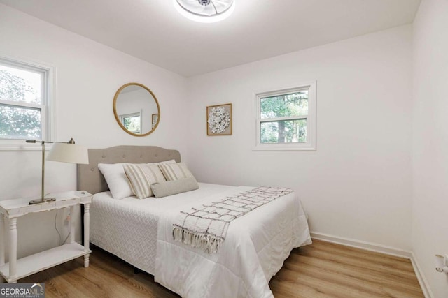 bedroom featuring wood-type flooring and multiple windows