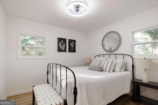 bedroom featuring hardwood / wood-style flooring and multiple windows