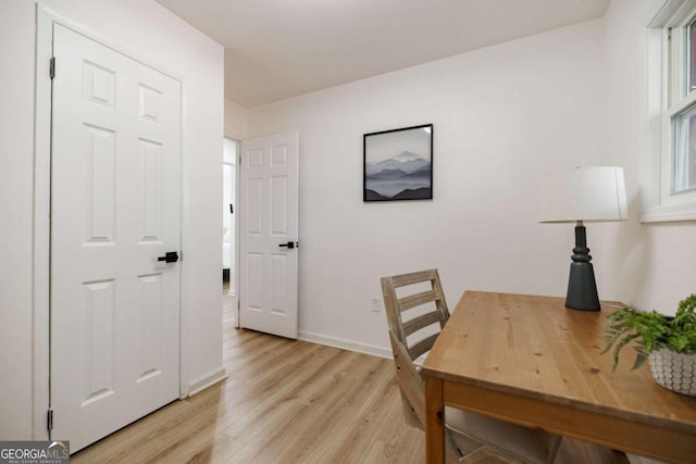 home office with light hardwood / wood-style floors