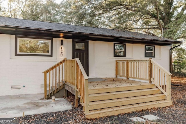 view of exterior entry with a patio area