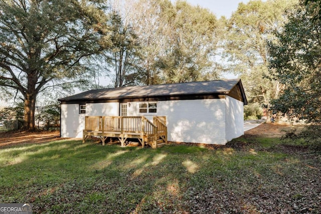 back of house with a yard and a deck