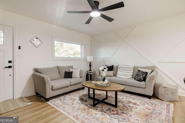 living room featuring ceiling fan and hardwood / wood-style flooring