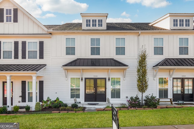 view of front facade with a front yard and french doors