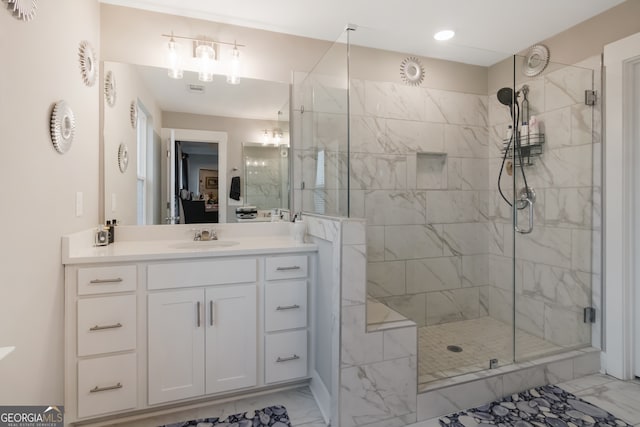 bathroom featuring vanity and a shower with door