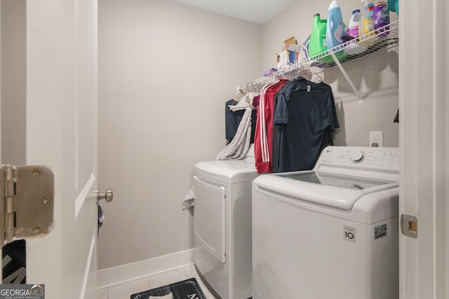 washroom featuring tile patterned floors and washer and dryer