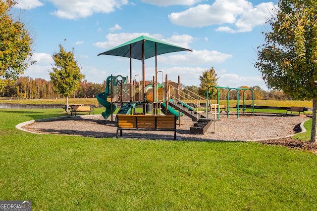 view of playground with a lawn