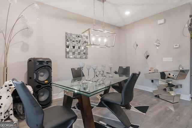 dining area with an inviting chandelier and hardwood / wood-style flooring