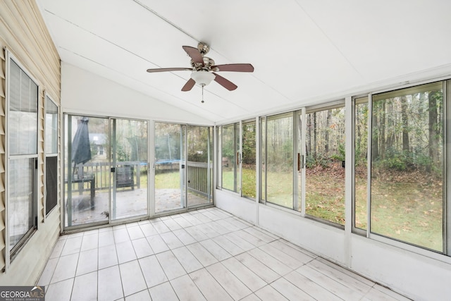 unfurnished sunroom featuring a wealth of natural light, lofted ceiling, and ceiling fan