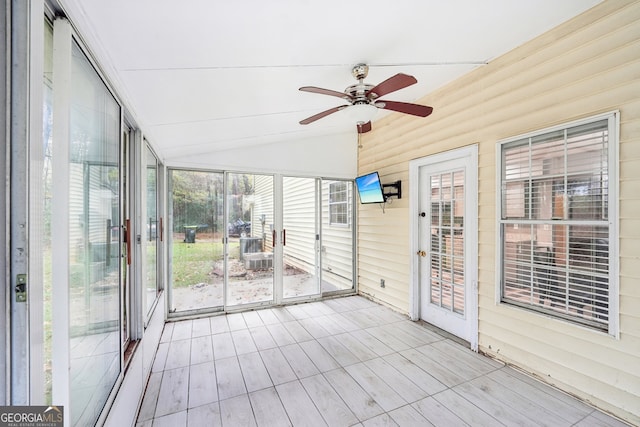 unfurnished sunroom featuring ceiling fan and vaulted ceiling