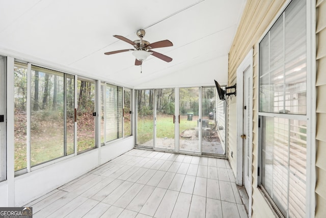 unfurnished sunroom with vaulted ceiling and ceiling fan