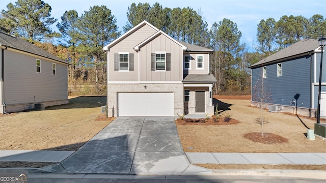 view of front of house with a front yard, a garage, and cooling unit