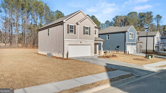 front facade featuring central AC and a garage