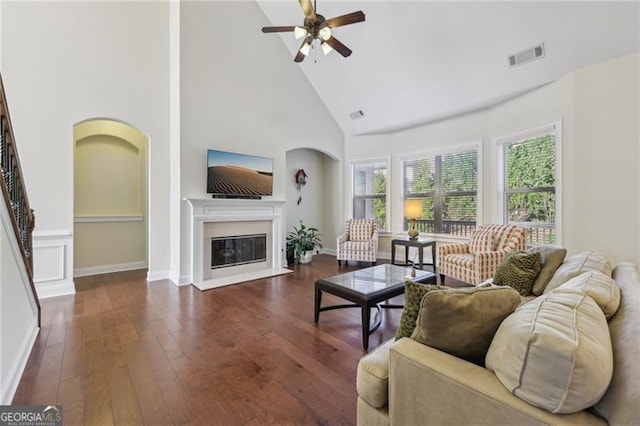 living room with dark hardwood / wood-style floors, high vaulted ceiling, and ceiling fan