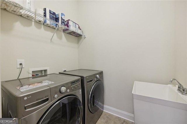 washroom with washing machine and clothes dryer