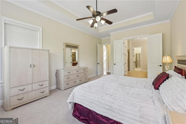 bedroom featuring light carpet, a tray ceiling, ceiling fan, and crown molding