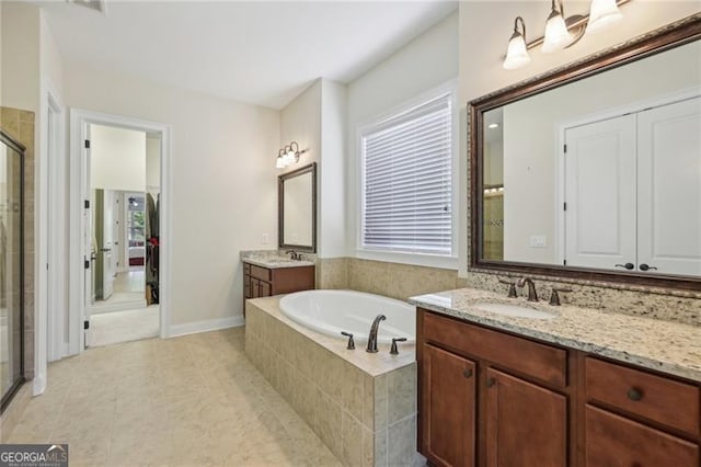 bathroom featuring vanity, tile patterned floors, and separate shower and tub