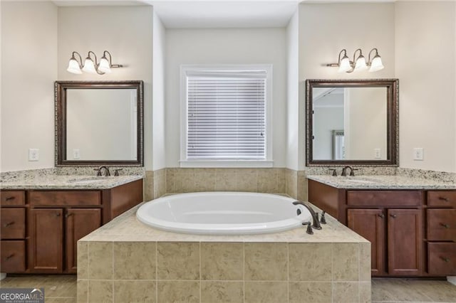 bathroom featuring vanity and tiled tub