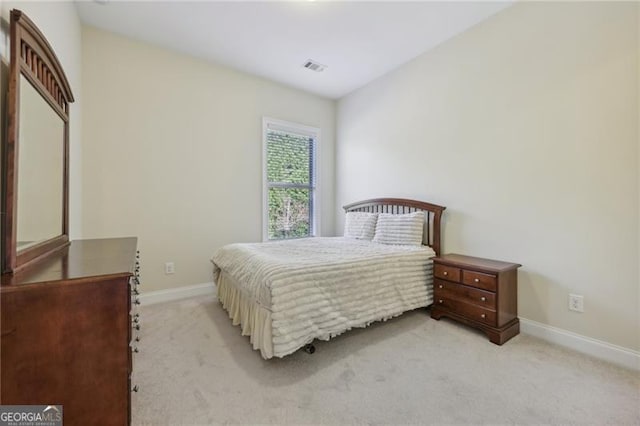 bedroom featuring light carpet