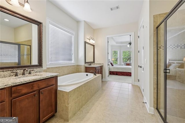 bathroom featuring tile patterned flooring, vanity, ceiling fan, and independent shower and bath