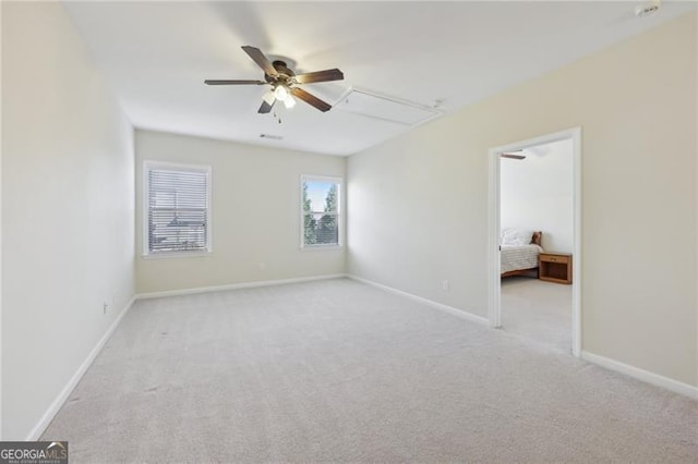 carpeted spare room with ceiling fan