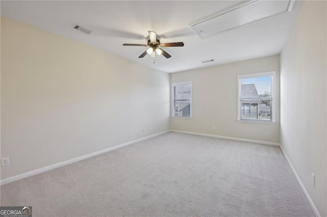 carpeted spare room with ceiling fan