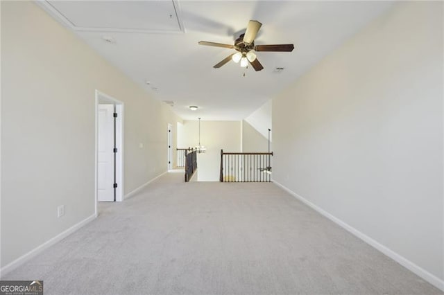 carpeted empty room featuring ceiling fan