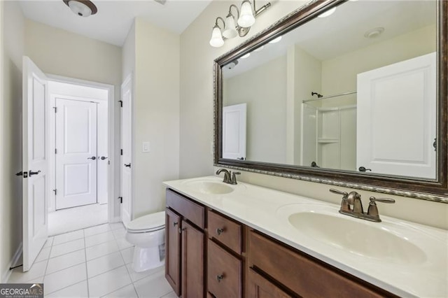 bathroom featuring tile patterned floors, vanity, and toilet