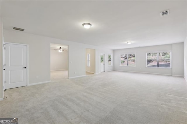 empty room featuring light carpet and ceiling fan