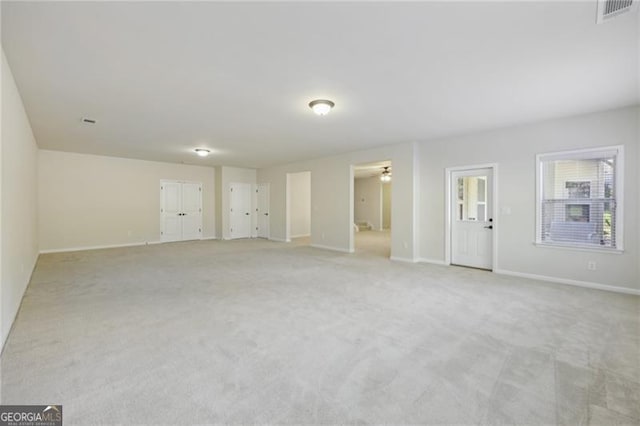 unfurnished room featuring light carpet