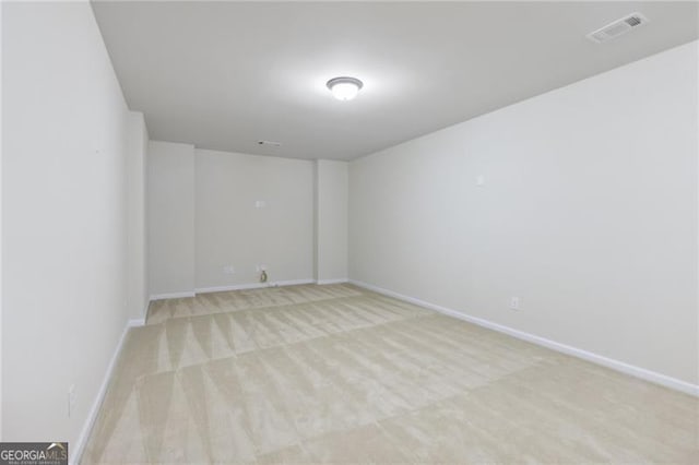 spare room featuring light colored carpet