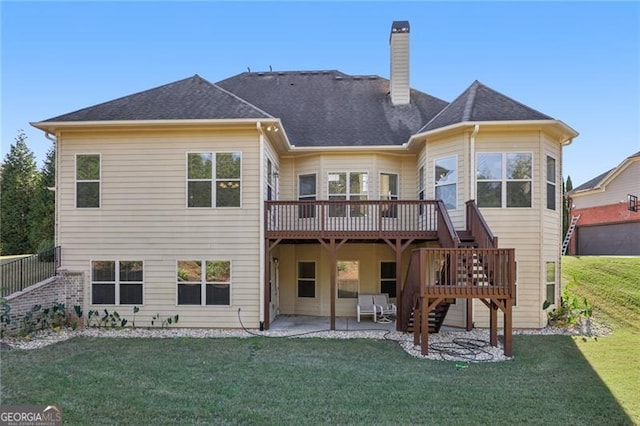 back of property featuring a patio area, a yard, and a deck