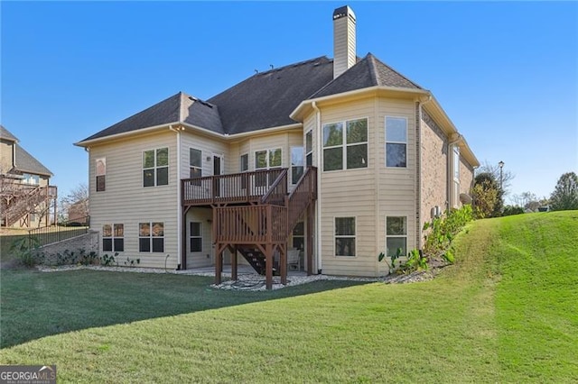 rear view of property featuring a patio, a lawn, and a wooden deck