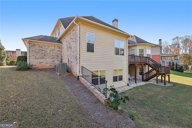 back of property with cooling unit, a deck, and a yard