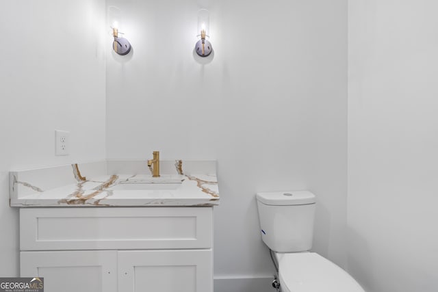 bathroom featuring toilet and vanity