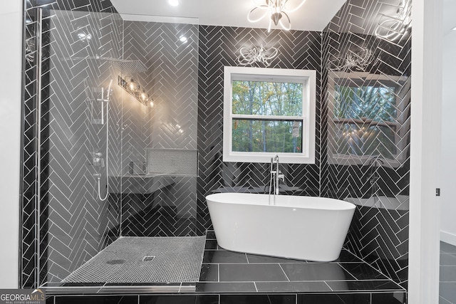 bathroom featuring a tub to relax in and tile walls