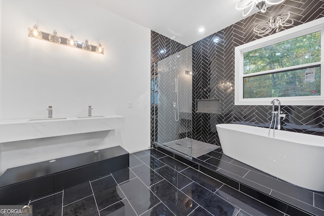 bathroom with separate shower and tub and tile patterned flooring