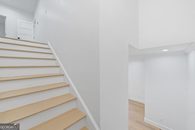 staircase with hardwood / wood-style flooring