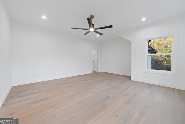 empty room with ceiling fan and light wood-type flooring